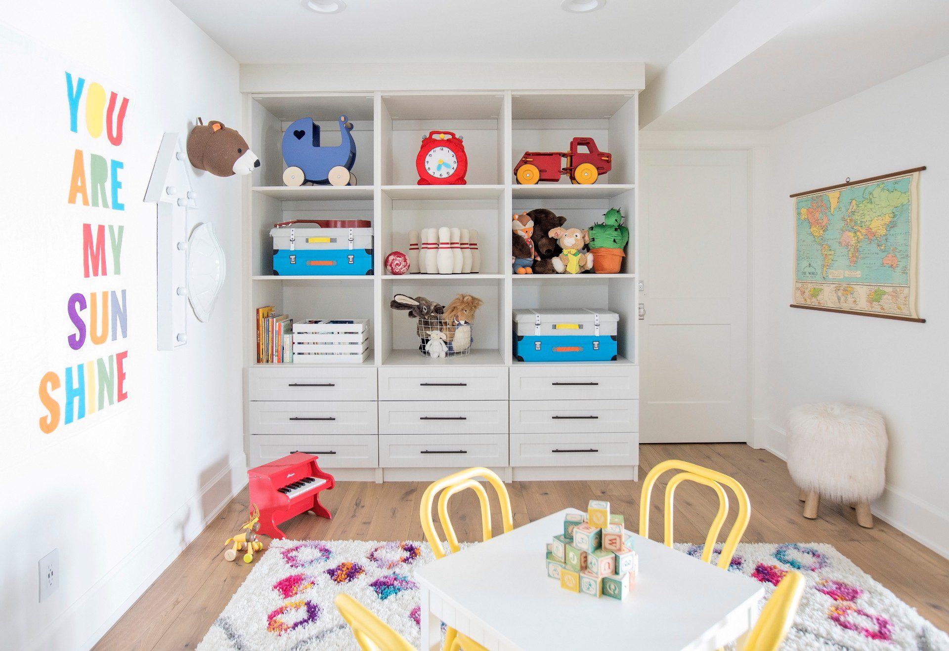 kid's room with table and custom closet to store toys