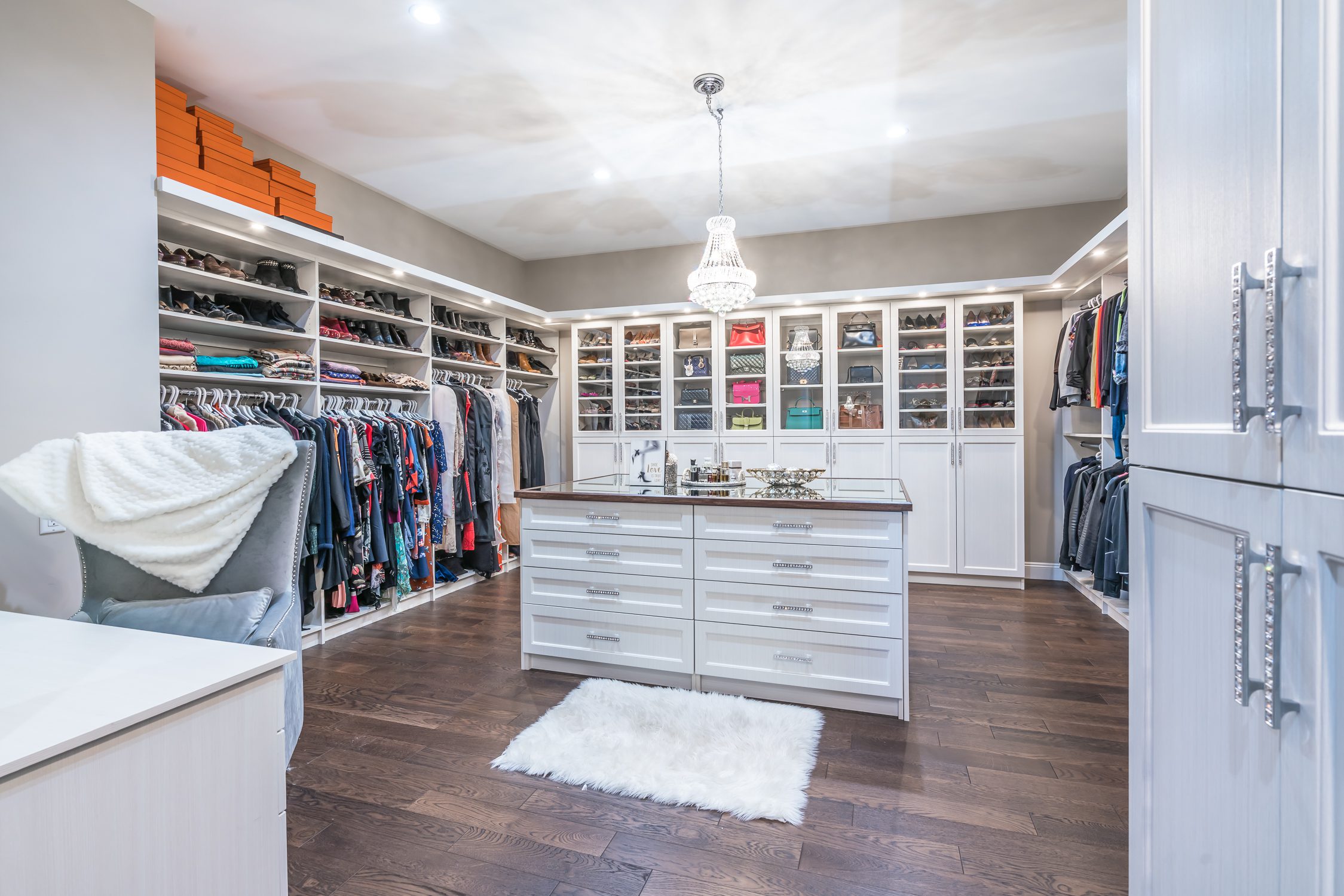 Spacious, luxurious walk-in closet with an island in the center